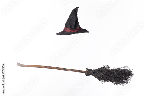 black broom and witch hat isolated on white background photo