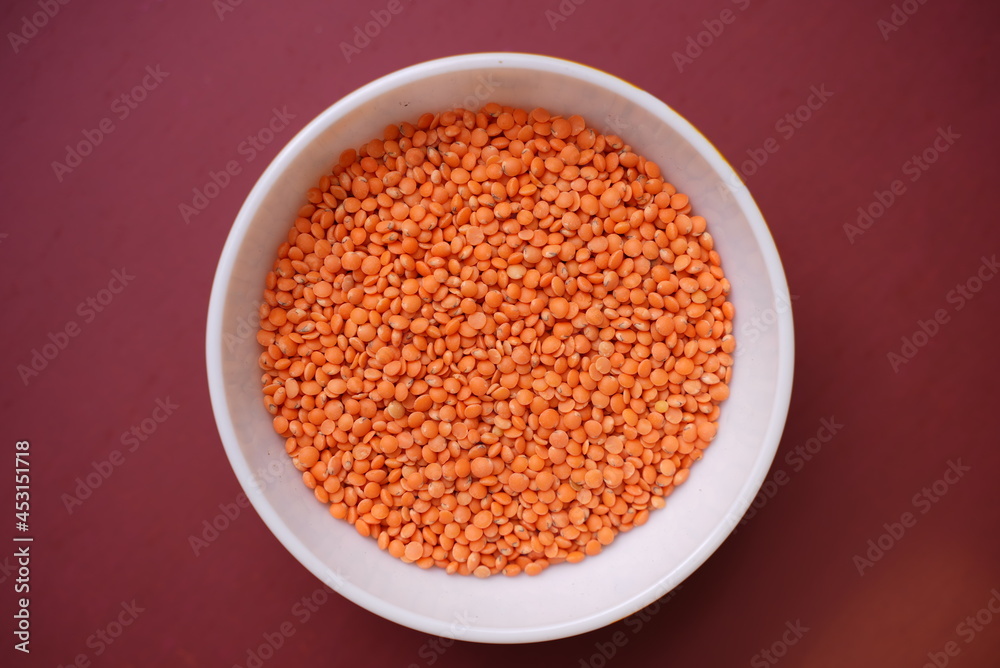 Some lentil grains on a clay bowl with colorful background Some lentil grains on a clay bowl with colorful background