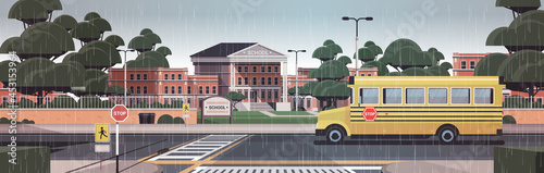 school building empty front yard with trees road crosswalk and school bus cityscape background horizontal