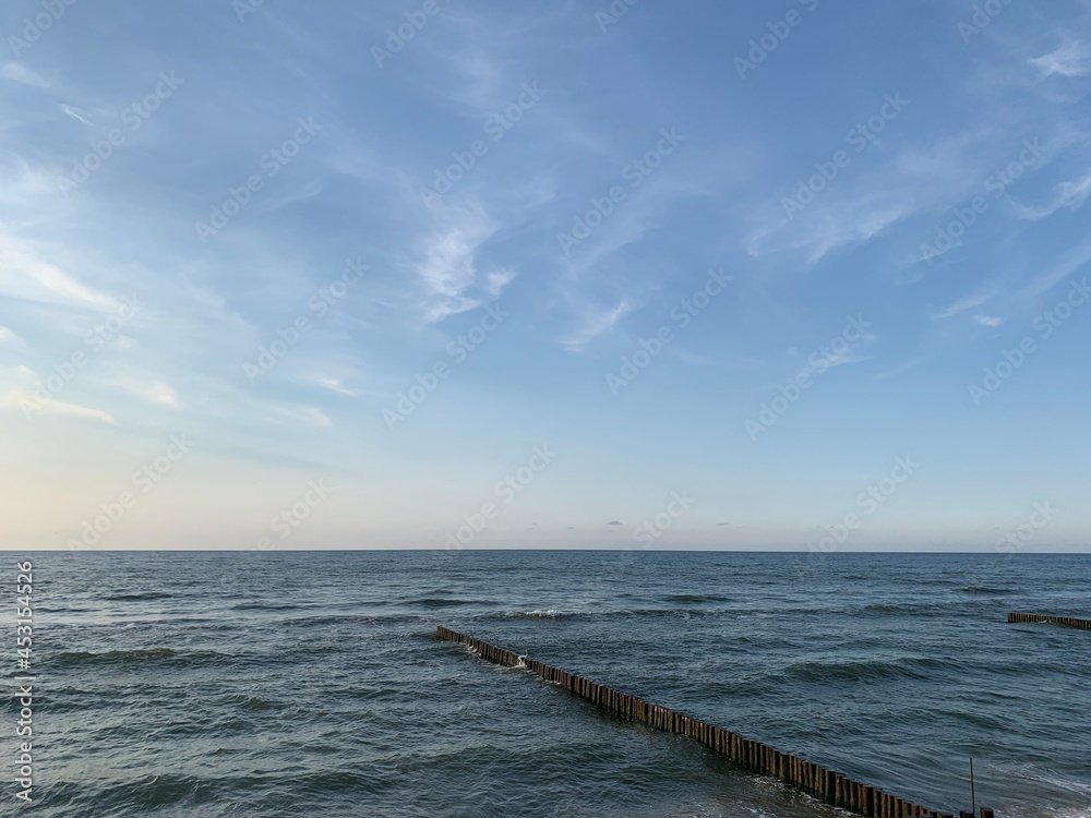 Breakwater construction in the sea, sea horizon, natural colors, romantic atmosphere Breakwater construction in the sea, sea horizon, natural colors, romantic atmosphere