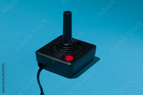 Leinwand Poster Vintage joystick with red buton on blue background