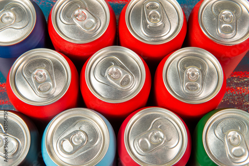 several aluminum soda cans in assorted colors