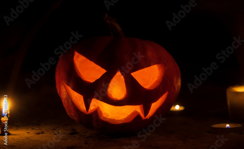 pumpkin head with candles in the dark on halloween night