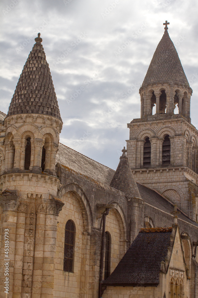 Notre Dame-La-Grande, Roman church over beautiful grey sky, France