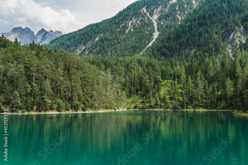 Fototapeta Naklejka Na Ścianę i Meble -  A view to an emerald green Blindsee lake surrounded by forest