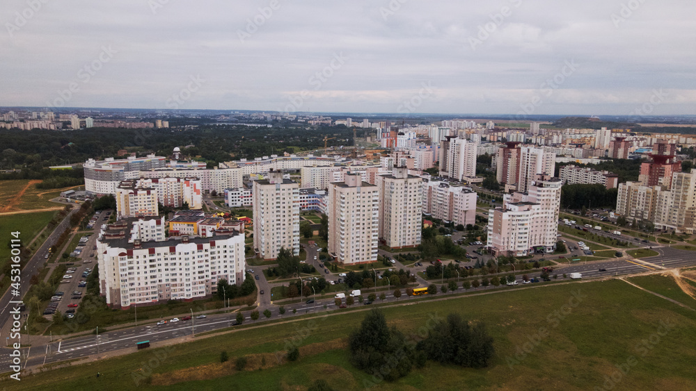 Obraz premium City block. Modern multi-storey buildings. Flying at dusk at sunset. Aerial photography.