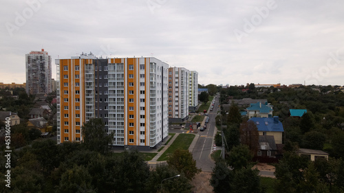 City block. Modern multi-storey buildings in the private sector. Flying at dusk at sunset. Aerial photography.