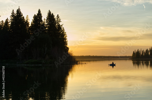A lone boater on Astotin Lake at Sunset