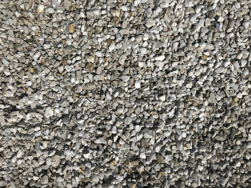 Textured granite surface. Background Pattern, Asphalt Road Texture. Small stones, minerals, thrash, gravel, and chalk are used to hold trees and decorate the interior and exterior design. Perfect for