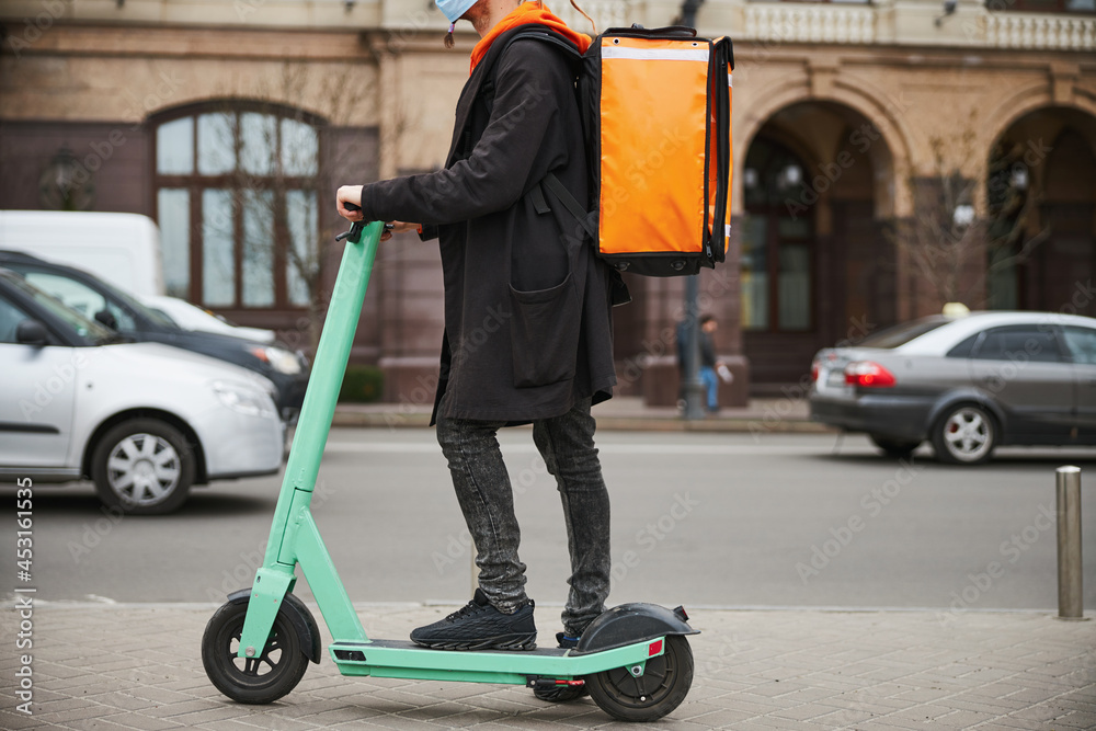 Focused photo on young man renting electrical scooter Focused photo on young man renting electrical scooter