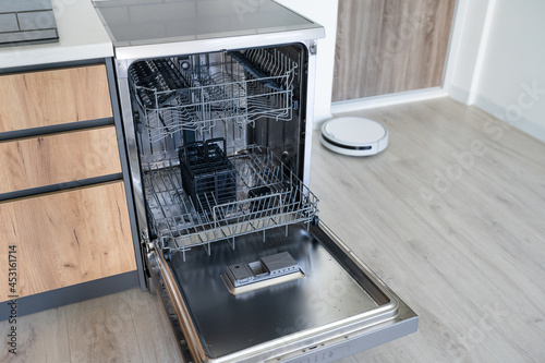 modern Half open empty dishwasher in a modern kitchen