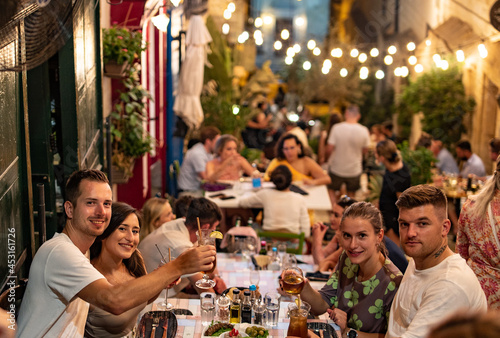 Friends having a dinner in Valletta stairs
