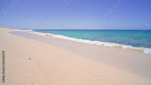 Blue Ocean, Yellow Sandy Beach Nature Tropical Islands Oahu Hawaii. Pacific Ocean. Turquoise sea background. Clear sunny day in the tropics.