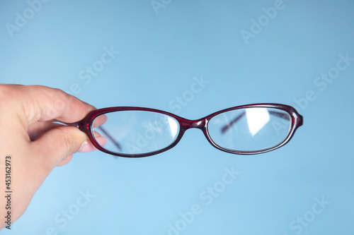 woman holding optical glasses