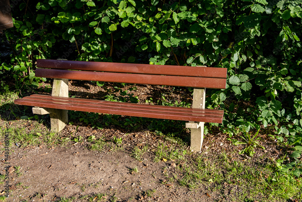 close-up of an empty brown bench by the side of the road close-up of an empty brown bench by the side of the road