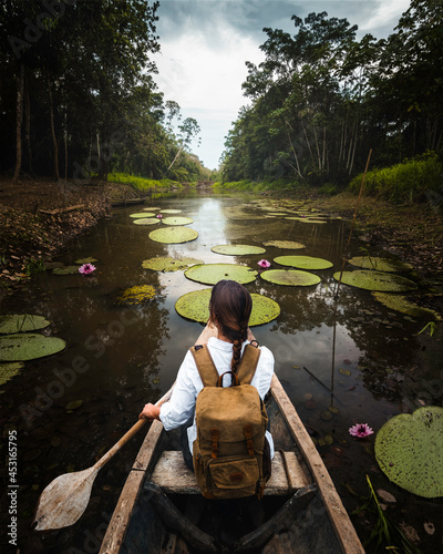 Woman explorer travels an Amazon river in a canoe photo