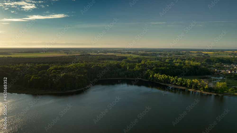 Aerial view of blue lakes and green forests on a sunny summer day in Poland. drone photography