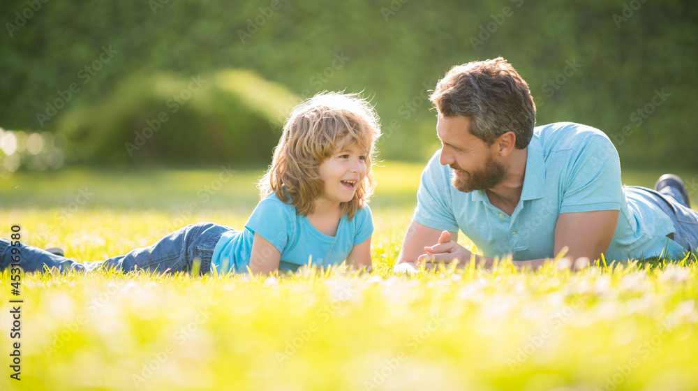 parenting and fatherhood. fathers day. happy cheerful father and son having fun in park parenting and fatherhood. fathers day. happy cheerful father and son having fun in park