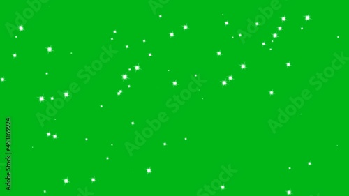 Little white sparkles shining on a green screen video photo
