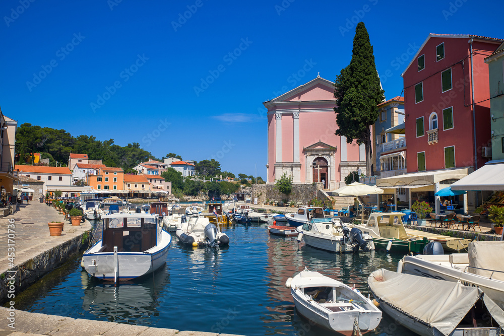 fisher boats and colorful houses in the harbor of veli losinj croatia
