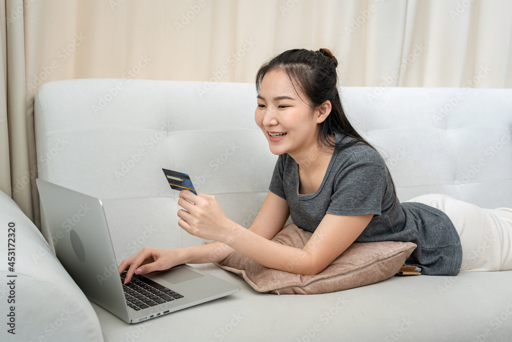 Freelance woman holding credit card for enter information to receive payment and check balance in banking app Freelance woman holding credit card for enter information to receive payment and check balance in banking app