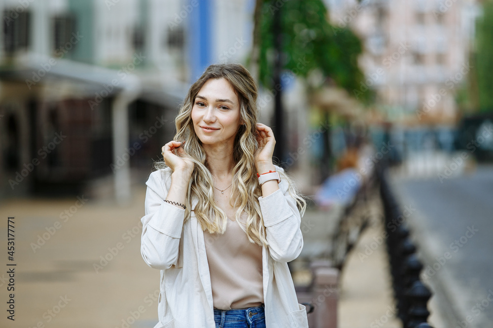 girl posing with a beautiful smile on the background of the city