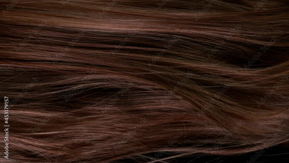 Super slow motion of beautiful healthy long smooth flowing brown hair. Filmed on high speed cinematic camera at 1000 fps.