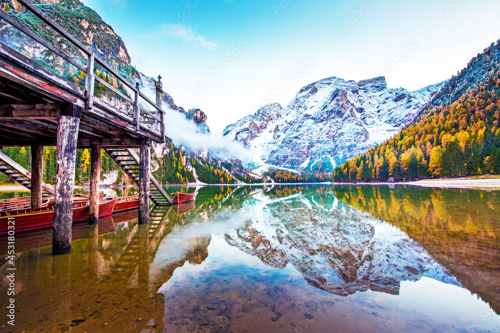 Magical beautiful fairy autumn landscape with boats on the lake on Fanes-Sennes-Braies natural park in the Dolomites in South Tyrol, Alps, Italy, Europe. Exotic amazing places. (harmony - concept)