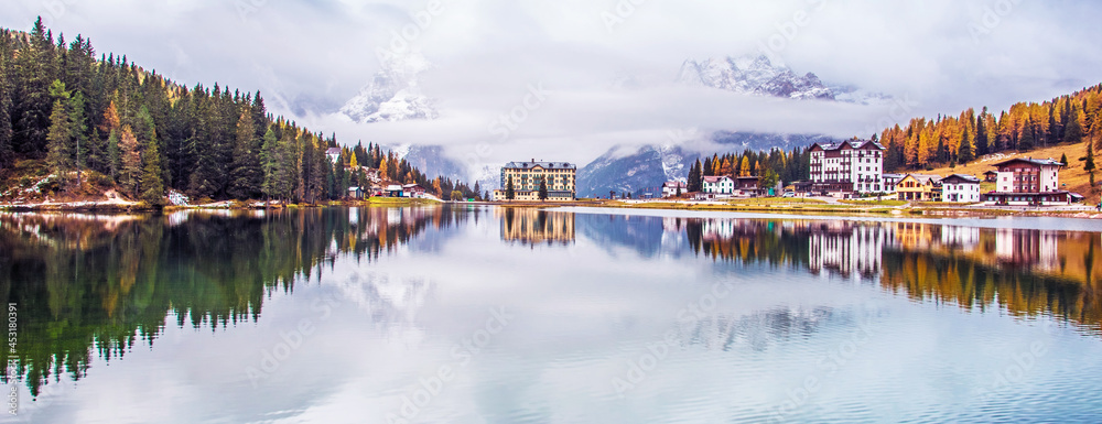 Dramatic magical beautiful autumn landscape with hotel near Lake Misurina in the Dolomites. National park Tre Cime di Lavaredo. Exotic amazing places. panorama