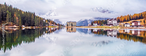 Obraz na płótnie Dramatic magical beautiful autumn landscape with hotel near Lake Misurina in the Dolomites. National park Tre Cime di Lavaredo. Exotic amazing places. panorama w salonie
