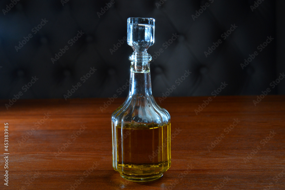 Jug of olive oil. on dark table background Jug of olive oil. on dark table background