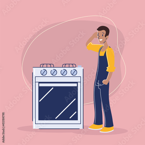 repairman in overall repairing oven
