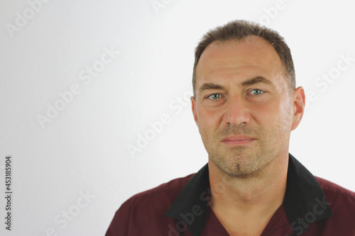 Man with serious look in dark shirt