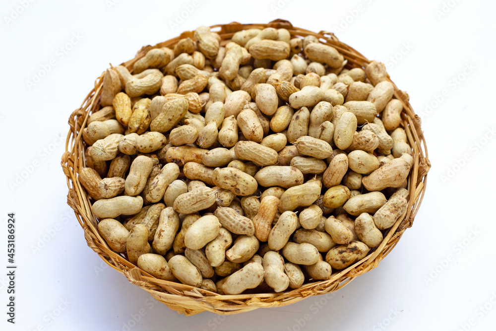 Raw peanuts in bamboo basket on white background. Raw peanuts in bamboo basket on white background.