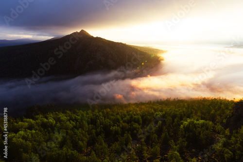 Fog in the mountains at sunrise. Morning fog in the mountains at dawn. Clouds in the mountains. Morning fog after rain. Mountains at dawn. Milk rivers. Copy space