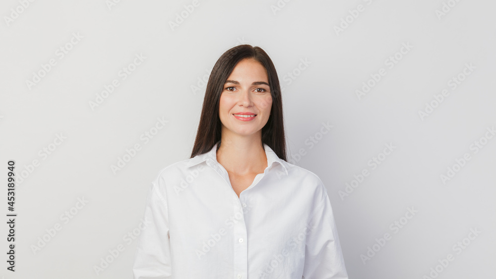 A young woman portrait isolated against a solid white background A young woman portrait isolated against a solid white background