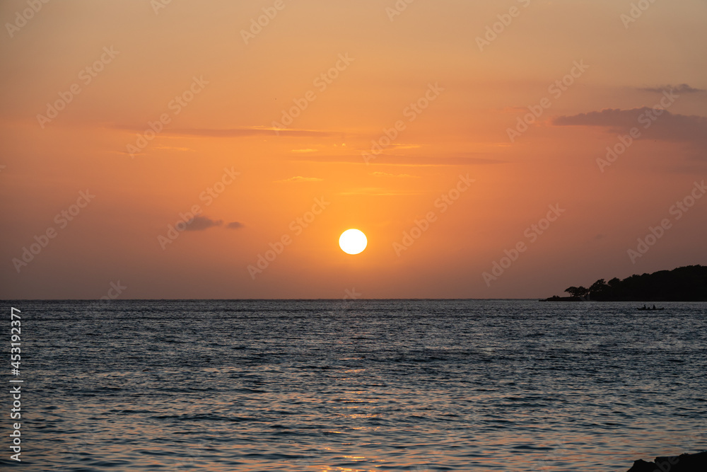 Stunning view of a sunset in the middle of the ocean Stunning view of a sunset in the middle of the ocean
