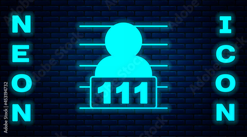 Glowing neon Suspect criminal icon isolated on brick wall background. The criminal in prison, suspected near the board. Vector