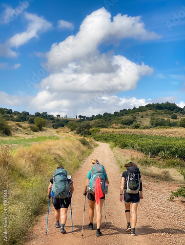 Three Pilgrim Women Walking the Way of St James Pilgrimage Trail Camino de Santiago through the Picturesque Landscapes of La Rioja