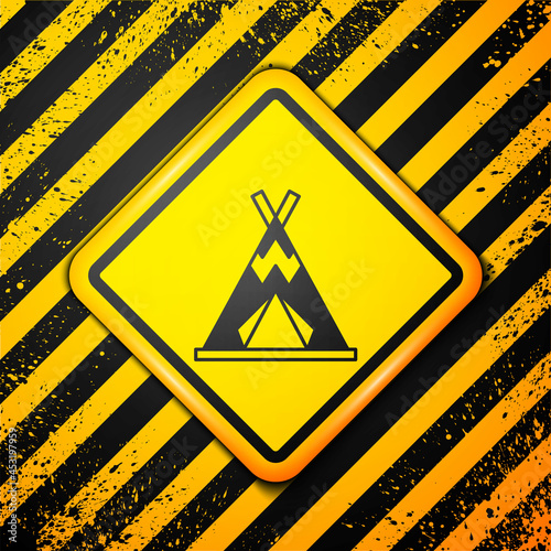 Black Traditional indian teepee or wigwam icon isolated on yellow background. Indian tent. Warning sign. Vector