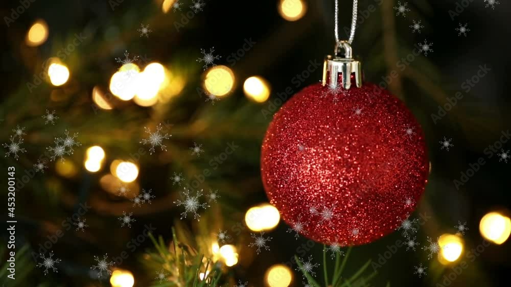 Animation of christmas ball and snow falling over christmas tree Animation of christmas ball and snow falling over christmas tree