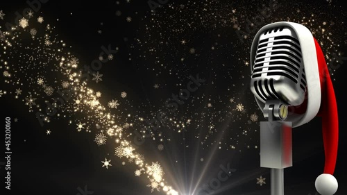 Animation of rerto microphone with santa hat over christmas star falling on black background photo
