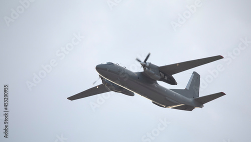 Military twin-engine transport aircraft on sky background.