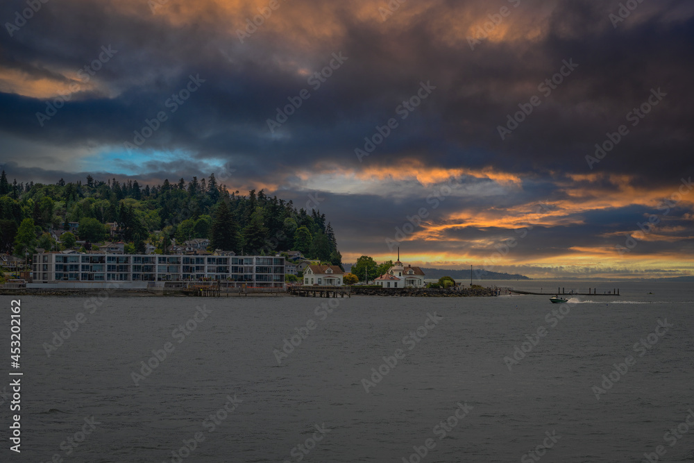 2021-08-26 THE PUGET SOUND SHORELINE WITH A STORMY CLOUD AND A LIGHT HOUSE IN MUKLITO WASHINGTON