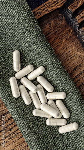 n-acetyl cysteine (NAC) supplement capsules  on burlap rag. immune prevention care concept photo