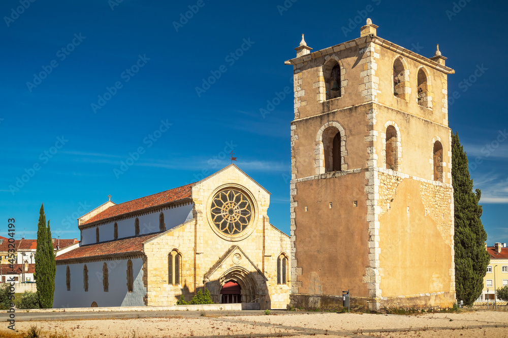 Perspective view of the church of Santa Maria do Olival in Tomar, Portugal, with its bell tower in the foreground.