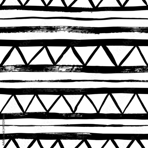 Seamless pattern with vector triangles and lines. Hand drawn aztec geometric background. Tribal and ethnic abstract wallpaper. Zig zag black paint lines in grunge style. Rubber dry brush texture.