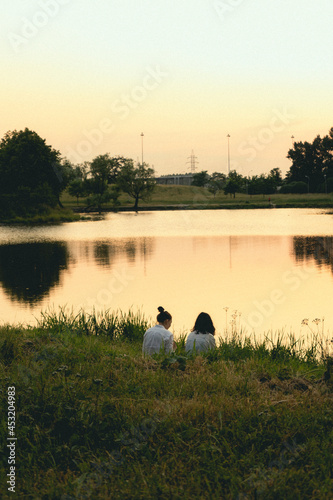 sunset on the lake with 2 girls