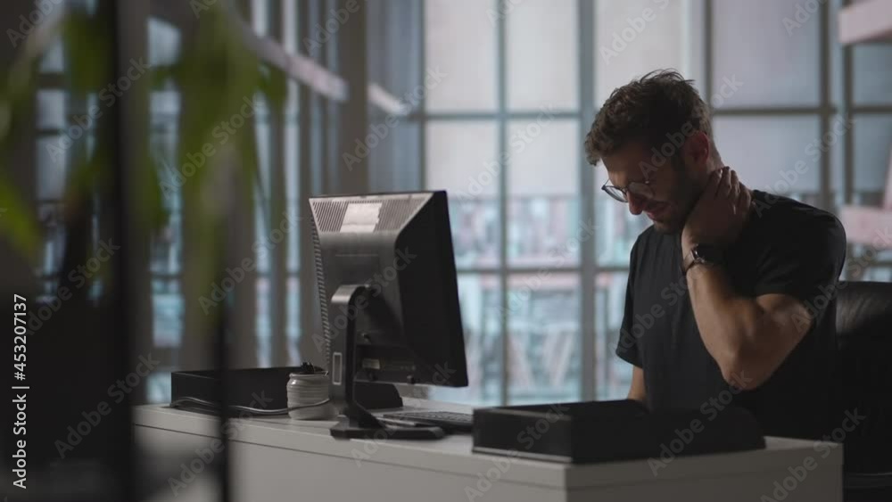 Tired Businessman having Neck Pain in Office. businessman in casual suit working and suffering with shoulder and neck pain in front of computer, Business health and office syndrome concept Tired Businessman having Neck Pain in Office. businessman in casual suit working and suffering with shoulder and neck pain in front of computer, Business health and office syndrome concept
