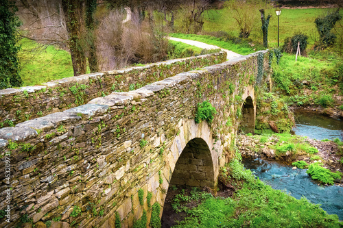 The Medieval Roman Bridge Puente Romano outside the Town of Sarria in Galicia, on the Way of St James Pilgrimage Trail Camino de Santiago photo